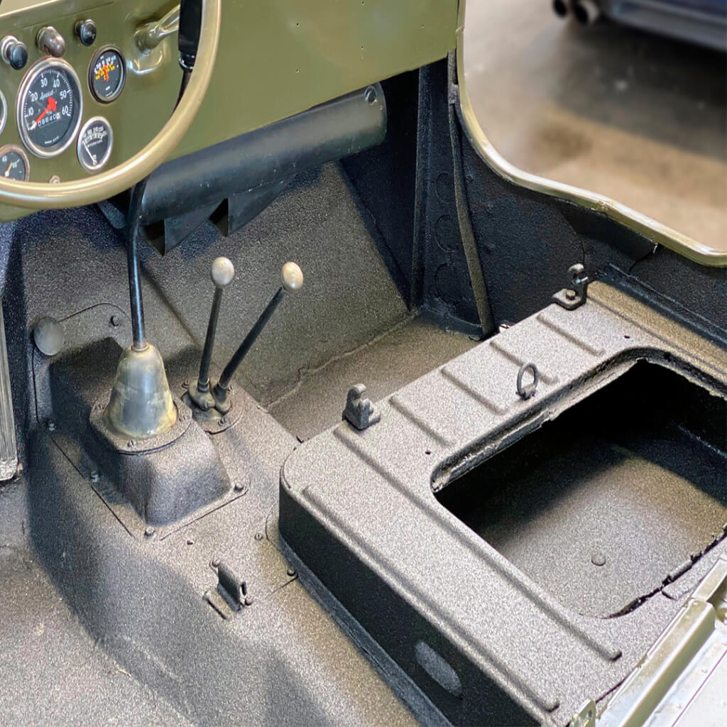 grey and green jeep with an interior floor coated with armaguard spray